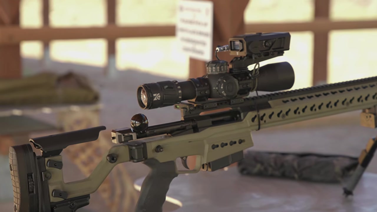 Close-up of the rifle's scope with a laser rangefinder mounted above it