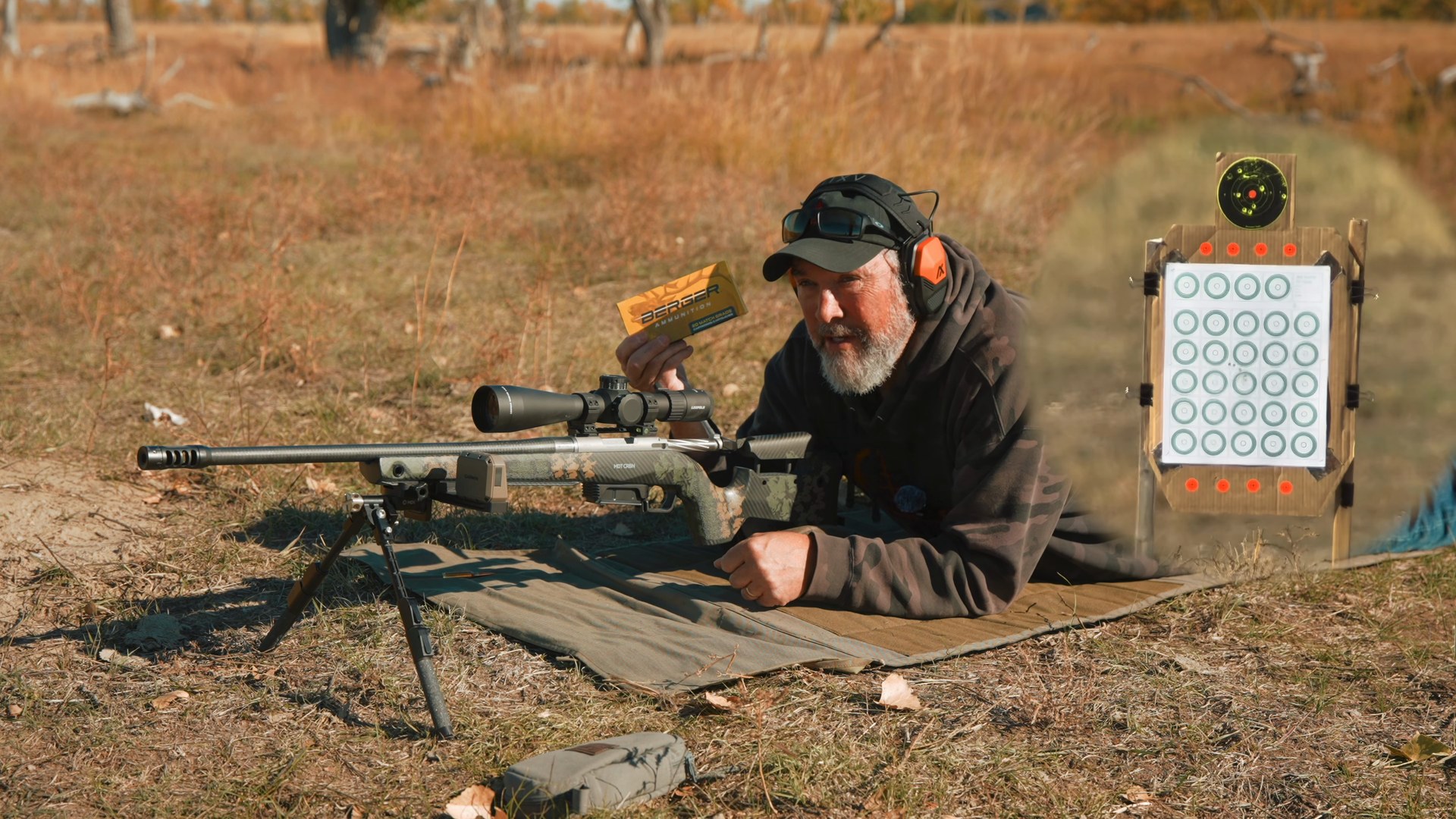 Joel holding up a box of Berger 140 grain Elite Hunter 6.5 PRC ammo next to the rifle