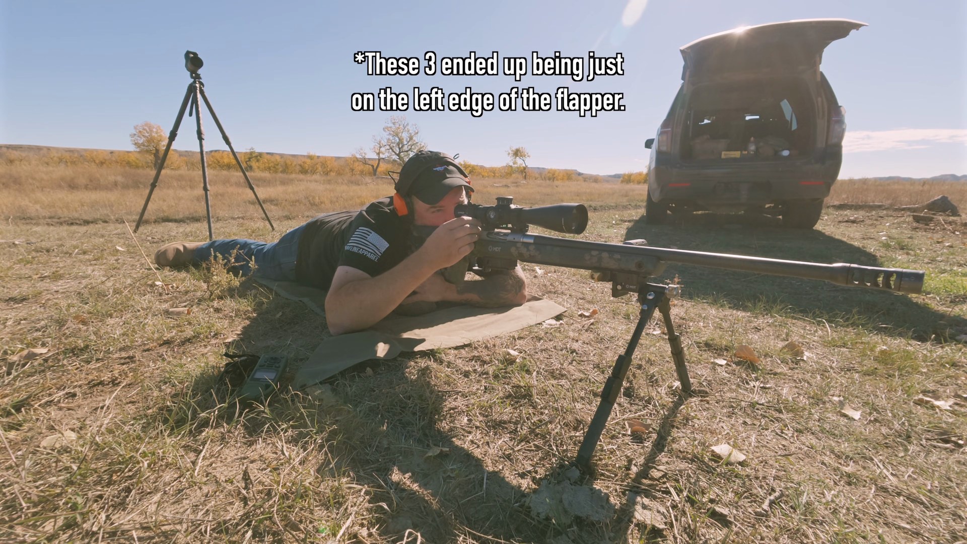 Joel prone with the 6.5 PRC rifle taking the 310 yard shot on steel, with an on-screen note that three shots landed on the left edge of the flapper